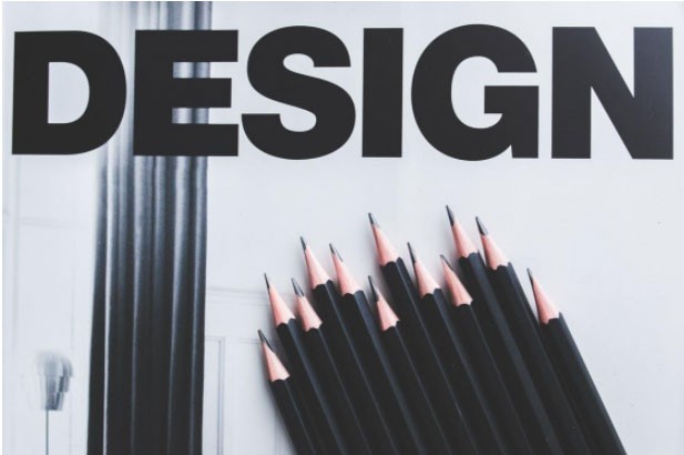 The word “design” in bold letters along with black pencils